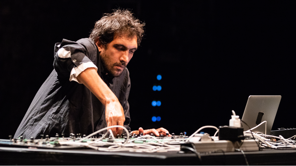 Close up of artist Tarek Ato­ui giving a music performance.