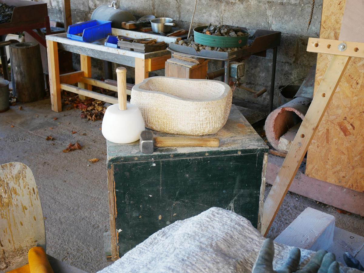 A work-in-progress of local yellow sandstone, with the grey granite at the front. Scottish Sculpture Workshop