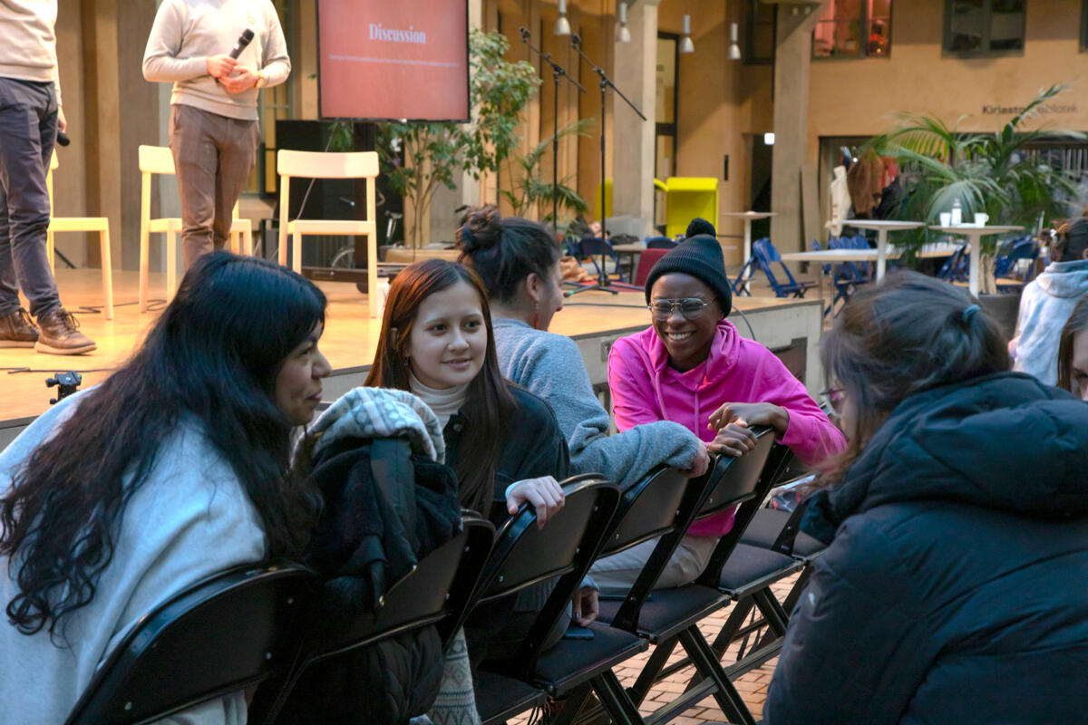 Students in the audience talking to each other.